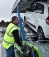 Renault Trucks driver attaching cars to be transported on a trailer